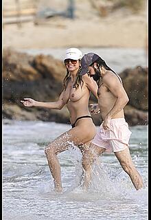 Heidi Klum in bikini and topless on the beach in St. Barths - December 12, 2025
