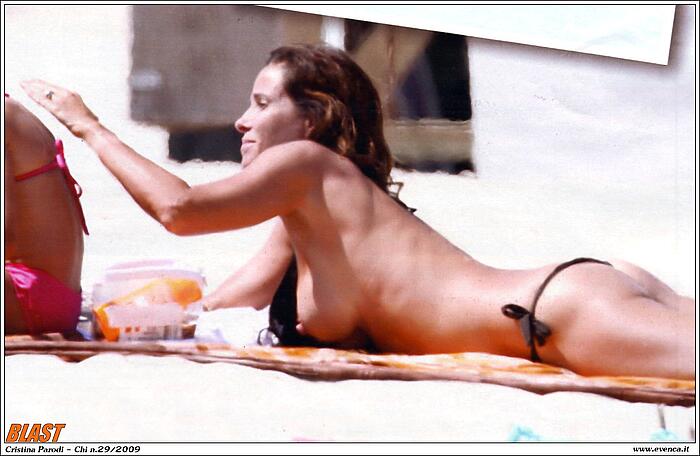 Cristina Parodi sunbathing topless on a beach