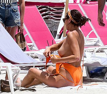 Kristen Doute topless on the beach in Miami