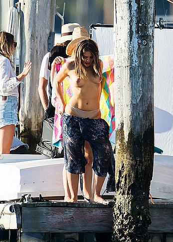 Olympia Valance topless while changing for a photoshoot