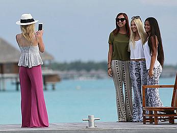 Ava Sambora paddle boarding on vacation in Bora Bora