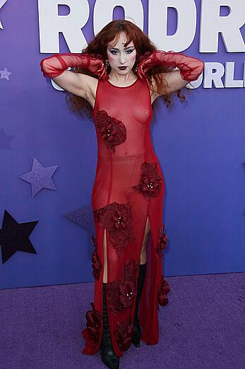 Chappell Roan braless in see through red dress at Olivia Rodrigo: GUTS World Tour premiere