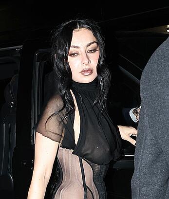 Charli XCX braless in sheer dress arrives at the Warner Music Brit Awards after party at Claridges Hotel in London