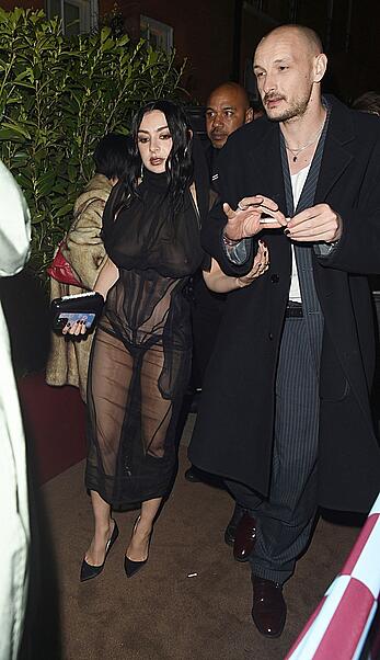 Charli XCX braless in sheer dress arrives at the Warner Music Brit Awards after party at Claridges Hotel in London