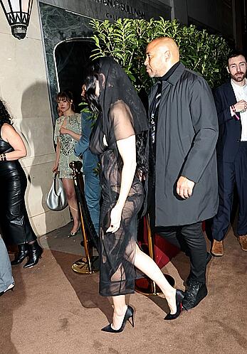Charli XCX braless in sheer dress arrives at the Warner Music Brit Awards after party at Claridges Hotel in London