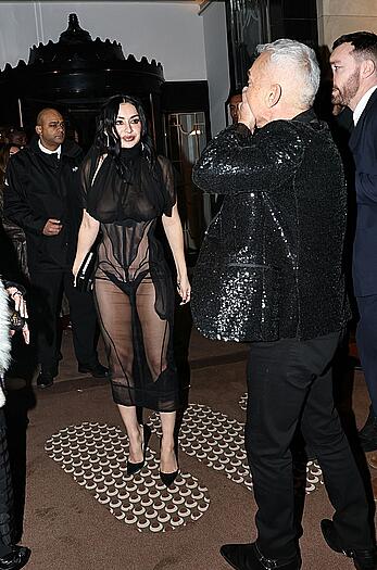 Charli XCX braless in sheer dress arrives at the Warner Music Brit Awards after party at Claridges Hotel in London