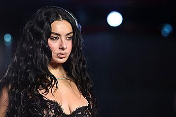 Charli XCX braless in see through dress at the Academy Museum 5th Annual Gala
