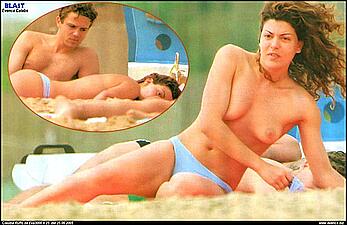 Italian actress Claudia Ruffo sunbathing topless on the beach