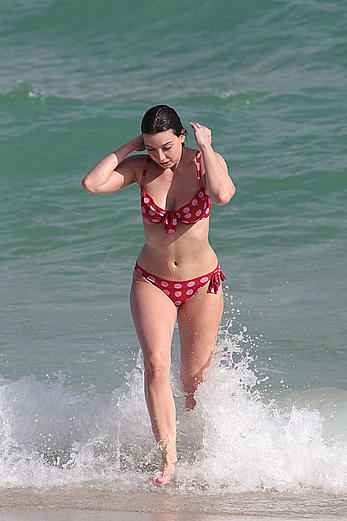 Daisy Lowe in red bikini on a beach