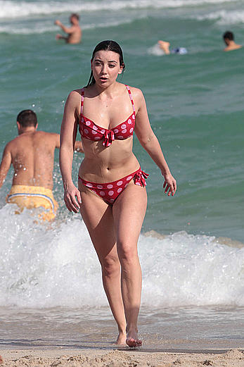 Daisy Lowe in red bikini on a beach