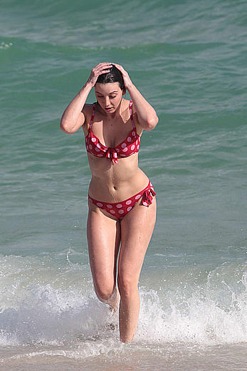 Daisy Lowe in red bikini on a beach