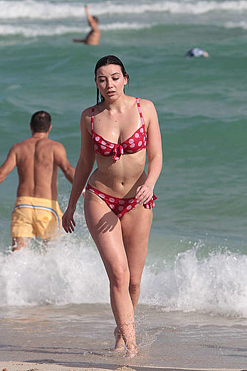 Daisy Lowe in red bikini on a beach