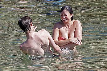 Daisy Lowe caught topless on the beach in Ibiza