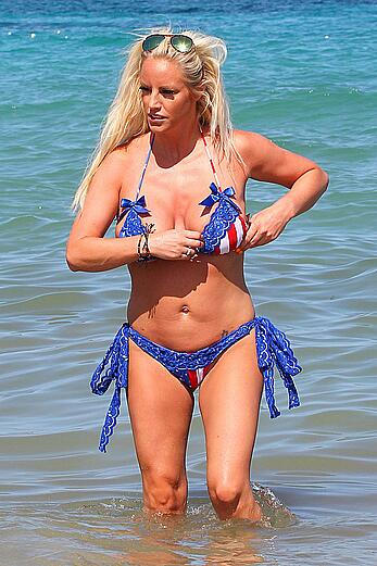 Danielle Mason in bikini and topless at the beach in Ibiza - July 08, 2014