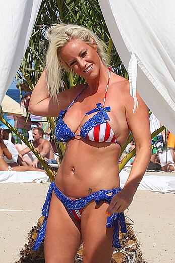 Danielle Mason in bikini and topless at the beach in Ibiza - July 08, 2014