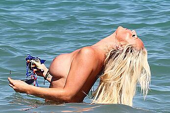 Danielle Mason in bikini and topless at the beach in Ibiza - July 08, 2014