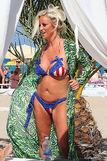 Danielle Mason in bikini and topless at the beach in Ibiza - July 08, 2014