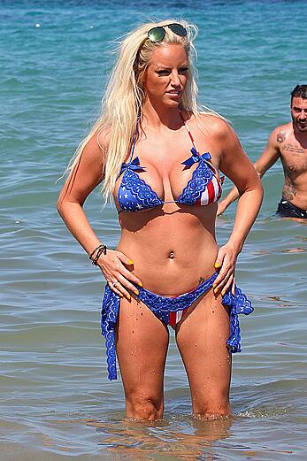 Danielle Mason in bikini and topless at the beach in Ibiza - July 08, 2014