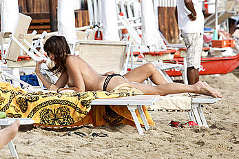 Emanuela Titocchia sunbathing topless on a beach