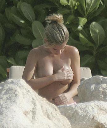 Emily Oldfield changing on a beach shows her nude boobs and ass