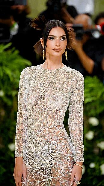 Emily Ratajkowski braless in a sheer dress