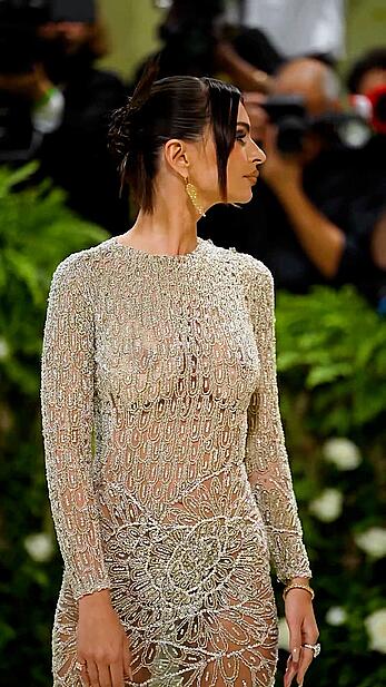 Emily Ratajkowski braless in a sheer dress