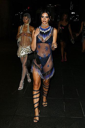 Emily Ratajkowski in a sheer ensemble attends the Met Gala After Party with friends