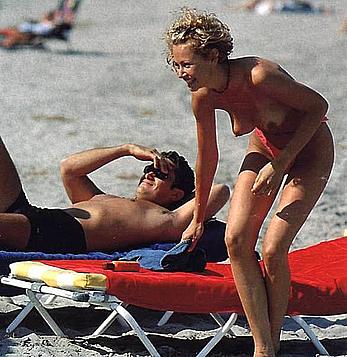Esther Arroyo topless in red bikini pants on a beach