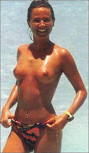 Italian television host and radio personality Federica Panicucci sunbathing topless on a beach