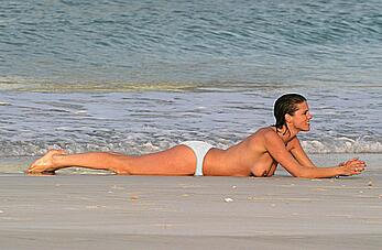 Heather Peace in bikini and topless on a beach