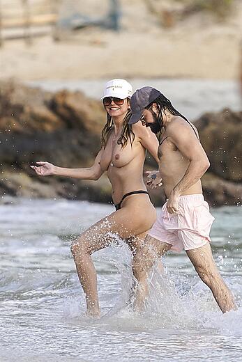 Heidi Klum in bikini and topless on the beach in St. Barths - December 12, 2025