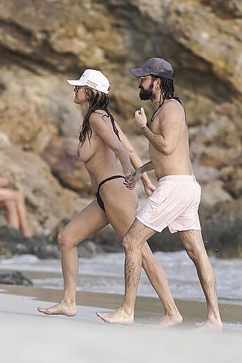 Heidi Klum in bikini and topless on the beach in St. Barths - December 12, 2025