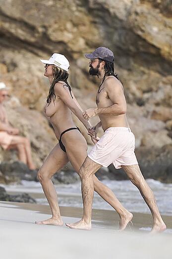 Heidi Klum in bikini and topless on the beach in St. Barths - December 12, 2025