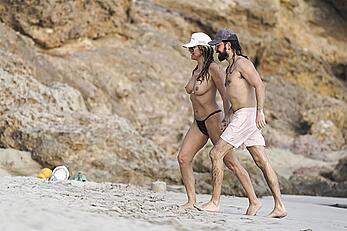 Heidi Klum in bikini and topless on the beach in St. Barths - December 12, 2025