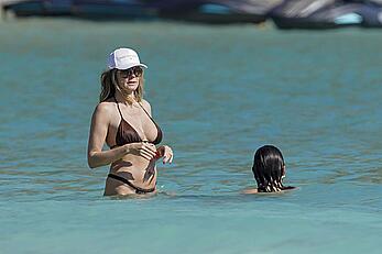 Heidi Klum in bikini and topless on the beach in St. Barths - December 12, 2025
