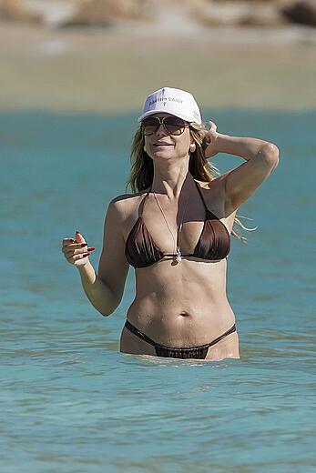 Heidi Klum in bikini and topless on the beach in St. Barths - December 12, 2025