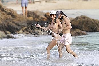Heidi Klum in bikini and topless on the beach in St. Barths - December 12, 2025