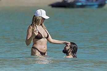 Heidi Klum in bikini and topless on the beach in St. Barths - December 12, 2025