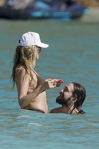 Heidi Klum in bikini and topless on the beach in St. Barths - December 12, 2025
