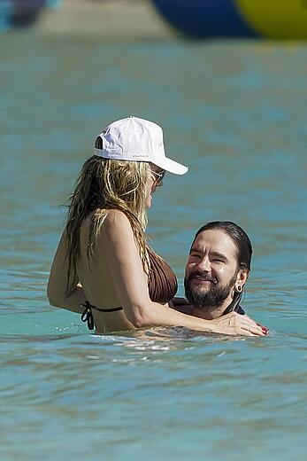 Heidi Klum in bikini and topless on the beach in St. Barths - December 12, 2025
