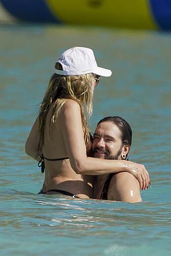 Heidi Klum in bikini and topless on the beach in St. Barths - December 12, 2025