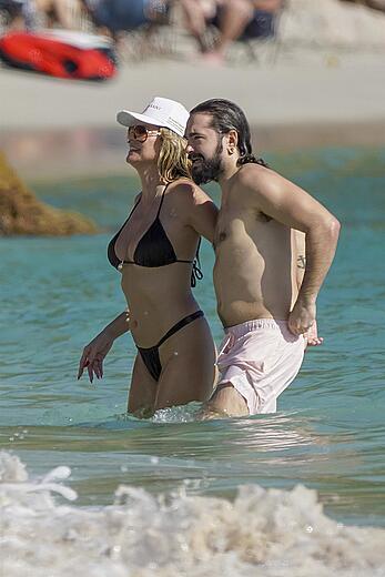 Heidi Klum in bikini and topless on the beach in St. Barths - December 12, 2025