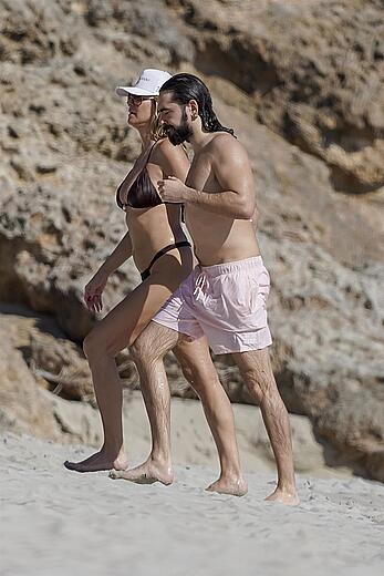 Heidi Klum in bikini and topless on the beach in St. Barths - December 12, 2025