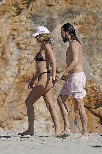 Heidi Klum in bikini and topless on the beach in St. Barths - December 12, 2025