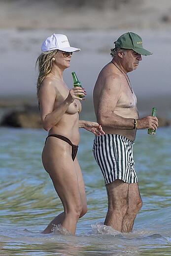 Heidi Klum in bikini and topless on the beach in St. Barths - December 12, 2025