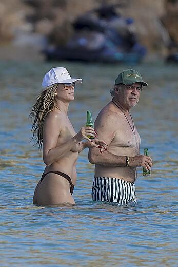 Heidi Klum in bikini and topless on the beach in St. Barths - December 12, 2025