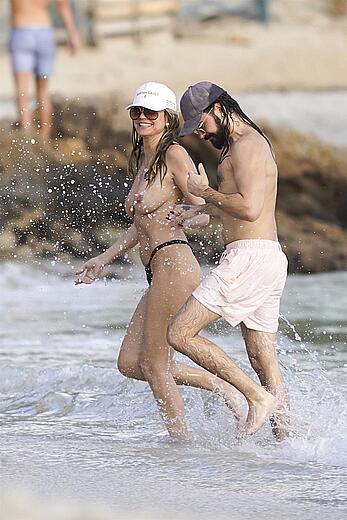 Heidi Klum in bikini and topless on the beach in St. Barths - December 12, 2025