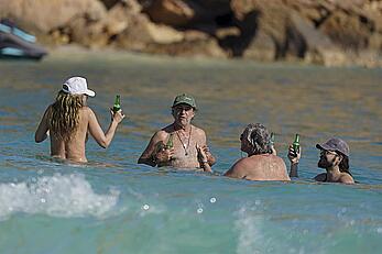 Heidi Klum in bikini and topless on the beach in St. Barths - December 12, 2025