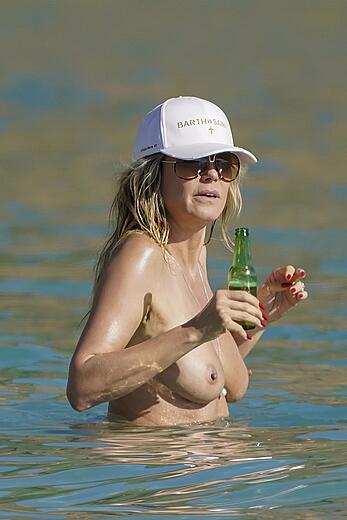 Heidi Klum in bikini and topless on the beach in St. Barths - December 12, 2025