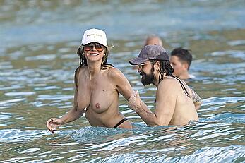 Heidi Klum in bikini and topless on the beach in St. Barths - December 12, 2025